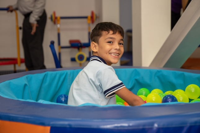 A boy playing in a ball pool