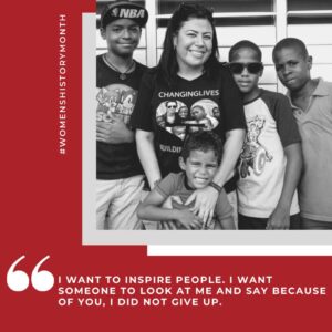 Executive Director Zaidy Cardenas with four boys with quote